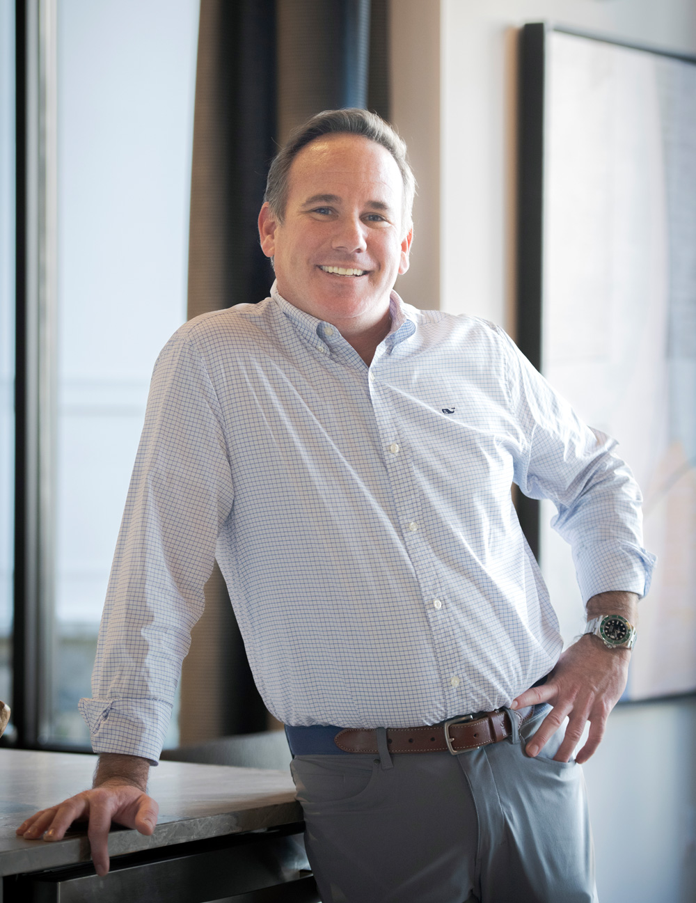 keith gillan casually leaning on counter