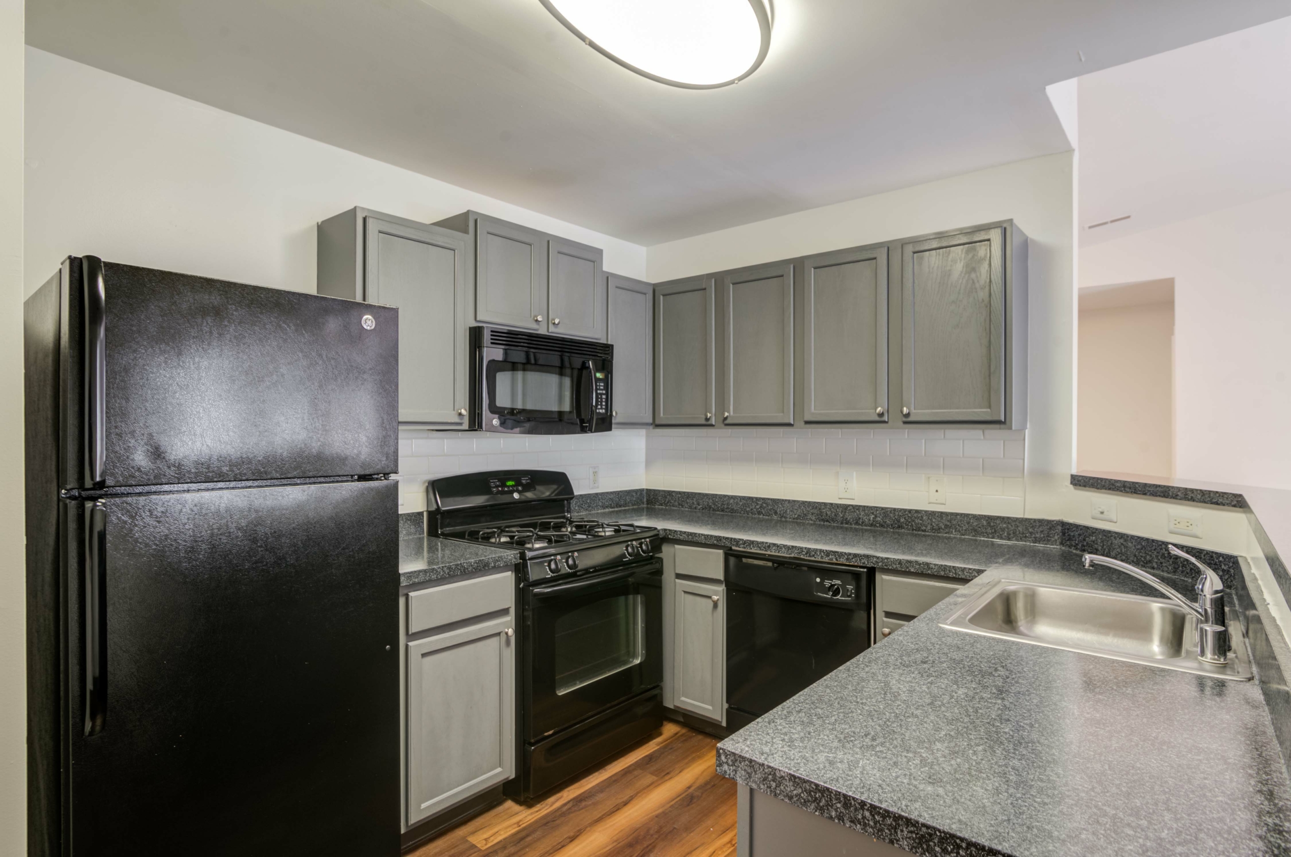 Kitchen with gray cabinets and gray countertops