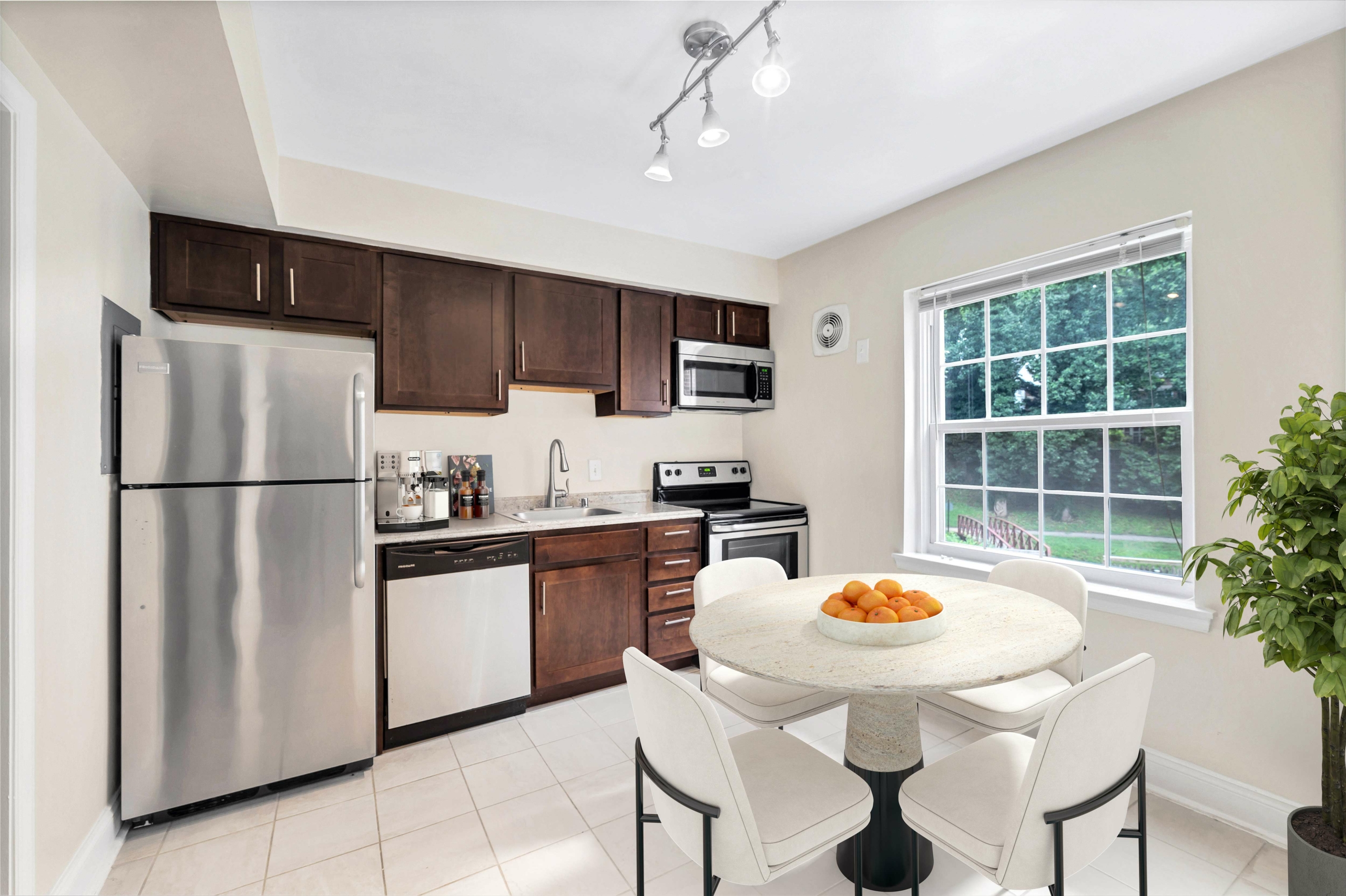 Kitchen with table and dark cabinets