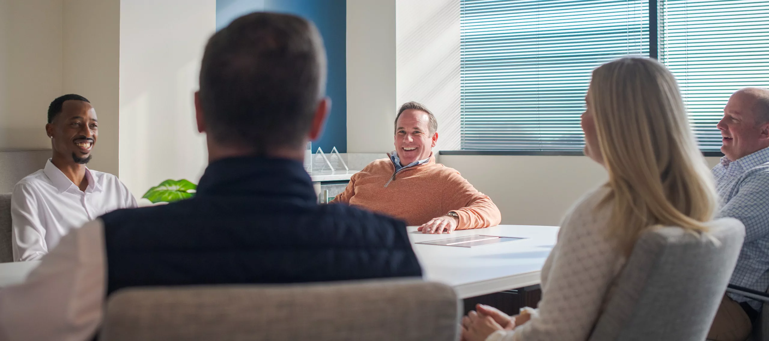Five people sitting at a conference table
